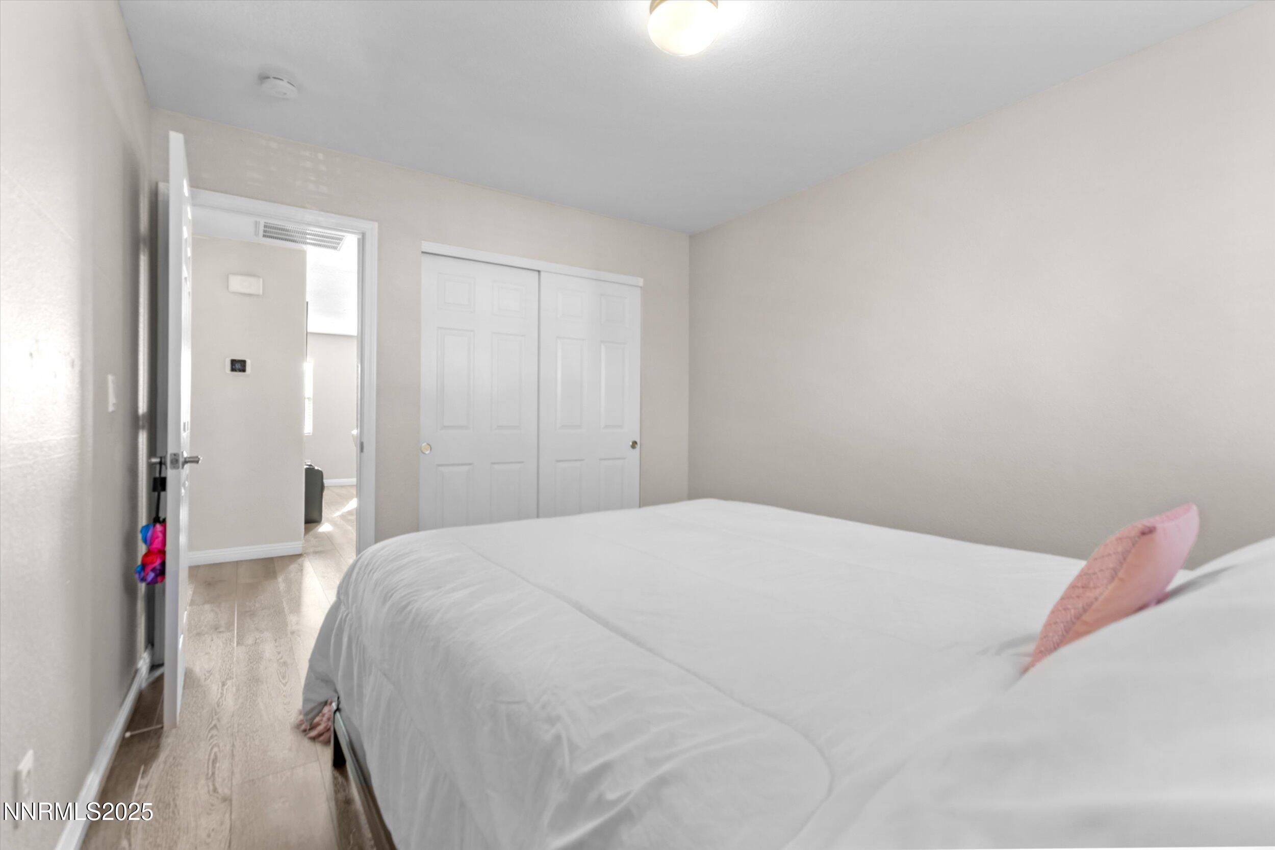 8922 Sorcha Street Reno, NV 89506 - Photo 39 of 47 a bedroom with a bed and a mirror