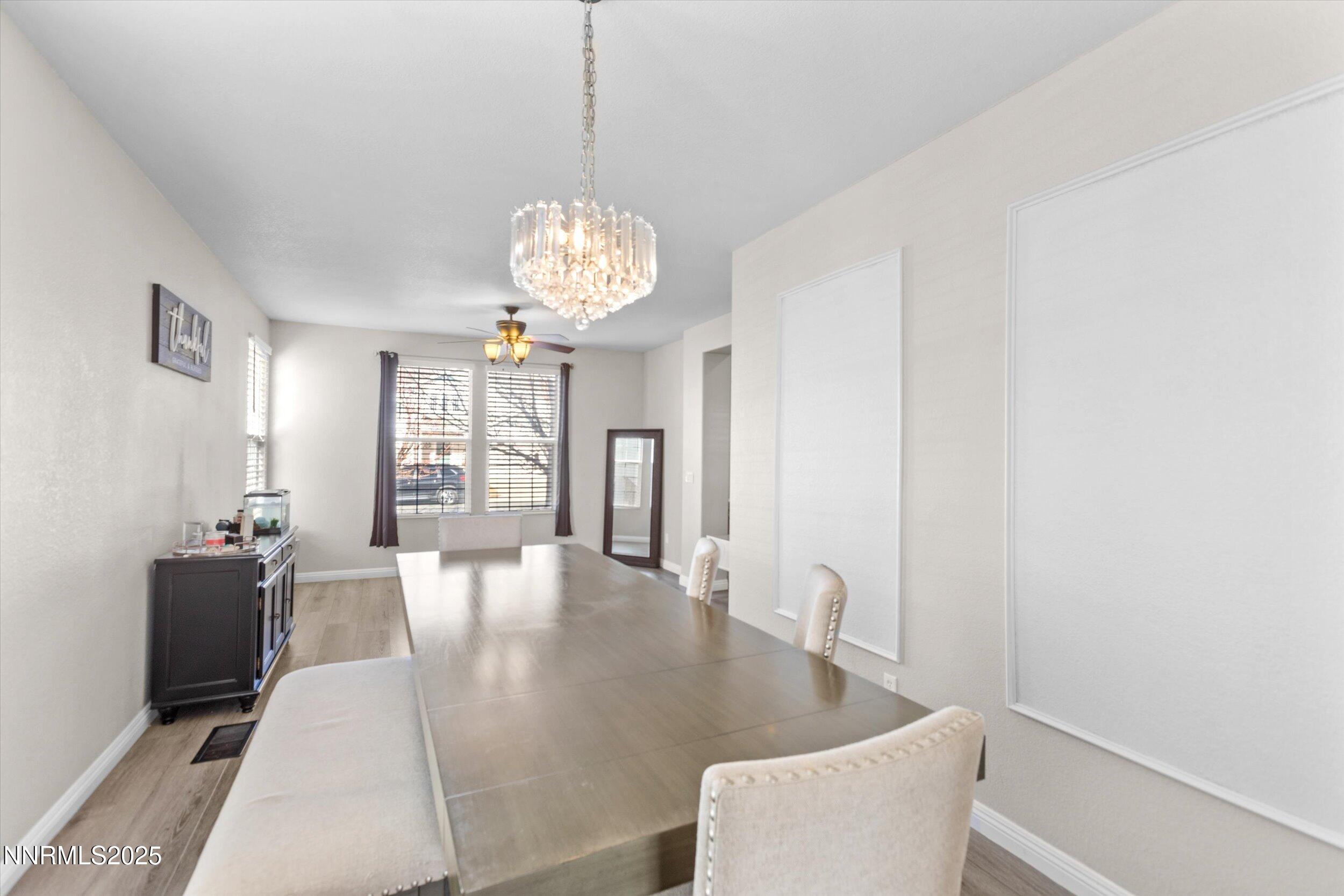 8922 Sorcha Street Reno, NV 89506 - Photo 10 of 47 a view of a dining room with furniture wooden floor and chandelier