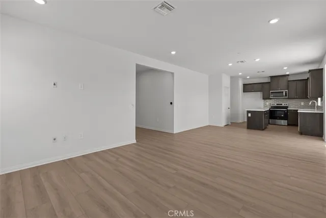 a view of kitchen and kitchen with wooden floor