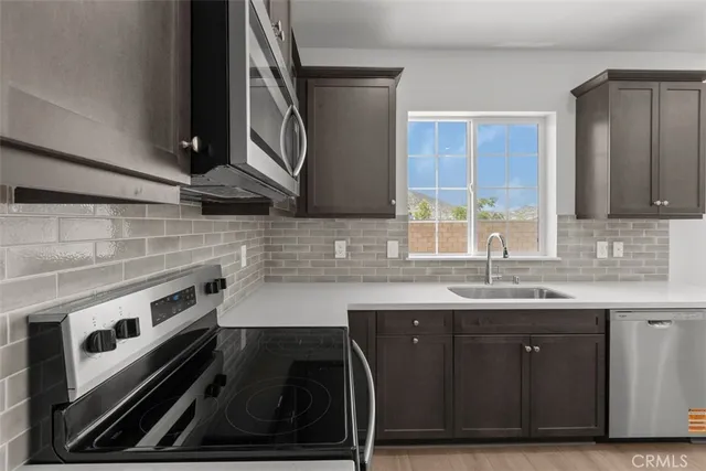 a kitchen with a sink stove and cabinets