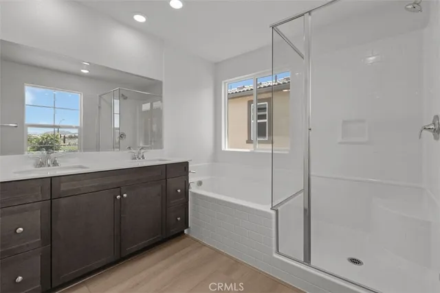 a spacious bathroom with a shower sink and mirror