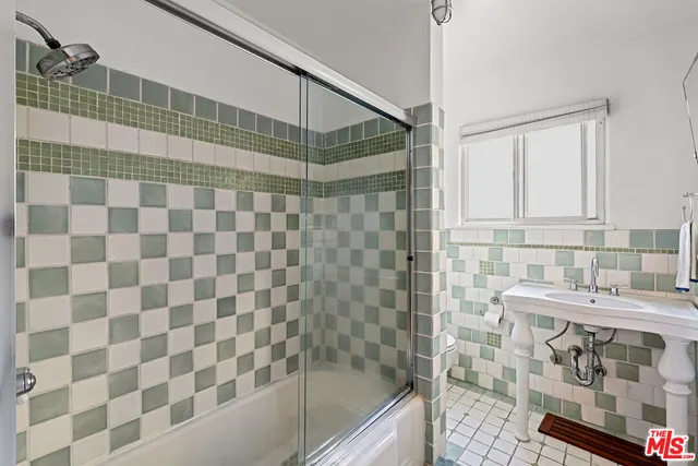 a bathroom with a shower and a sink