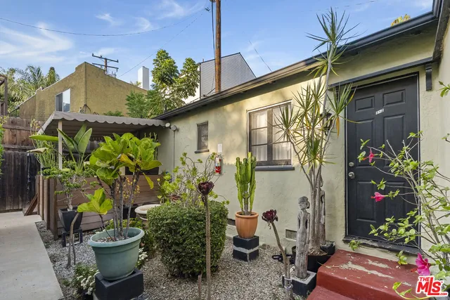 a front view of a house with outdoor seating