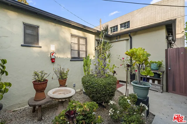 an empty room with windows and cabinet