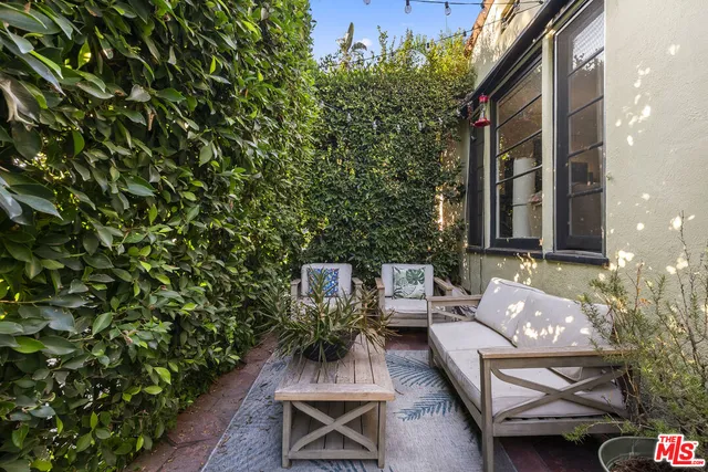 a view of backyard with outdoor seating and green space