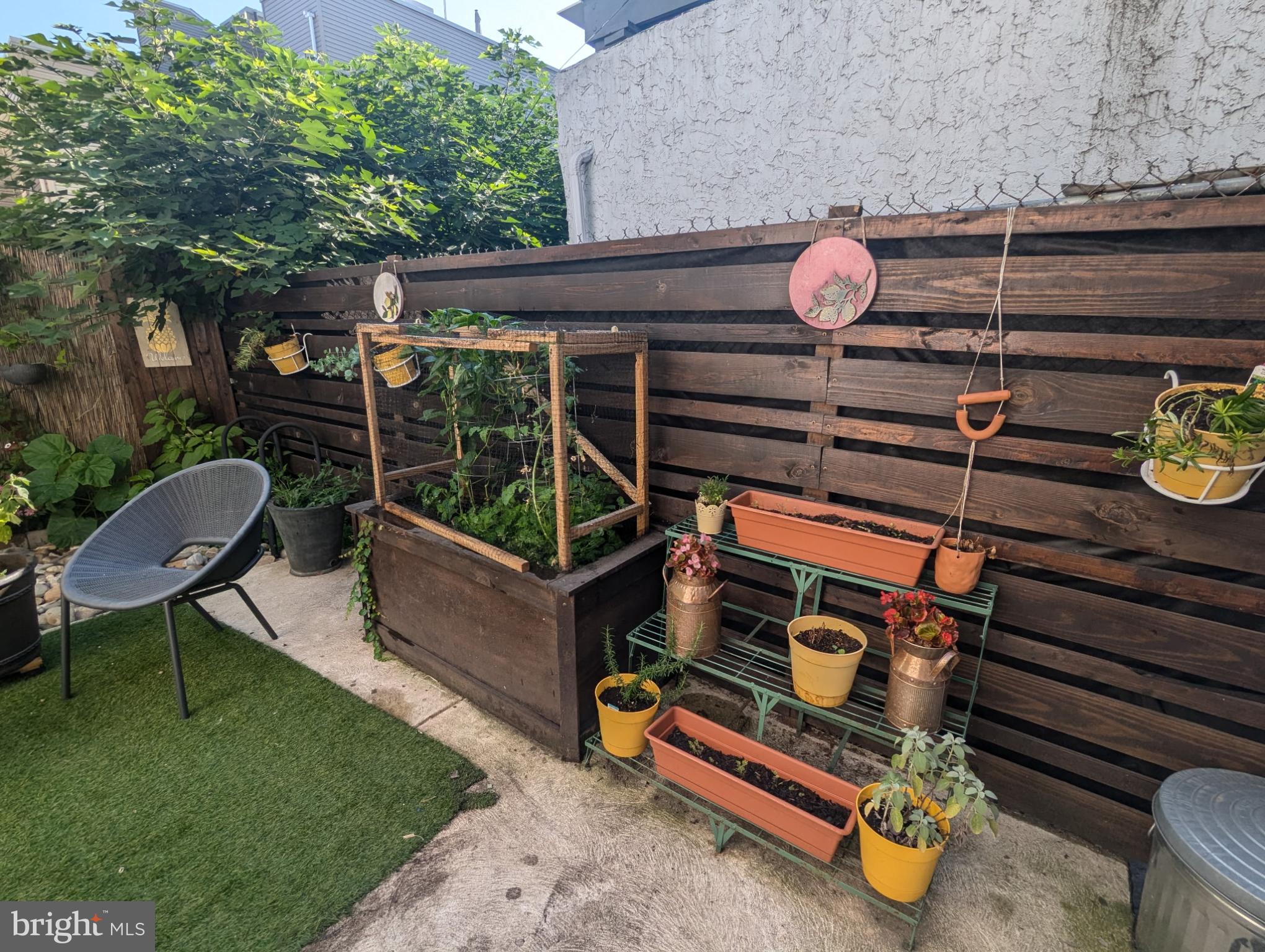 1729 Reed Street Philadelphia, PA 19146 - Photo 2 of 6 a backyard of a house with barbeque oven table and chairs