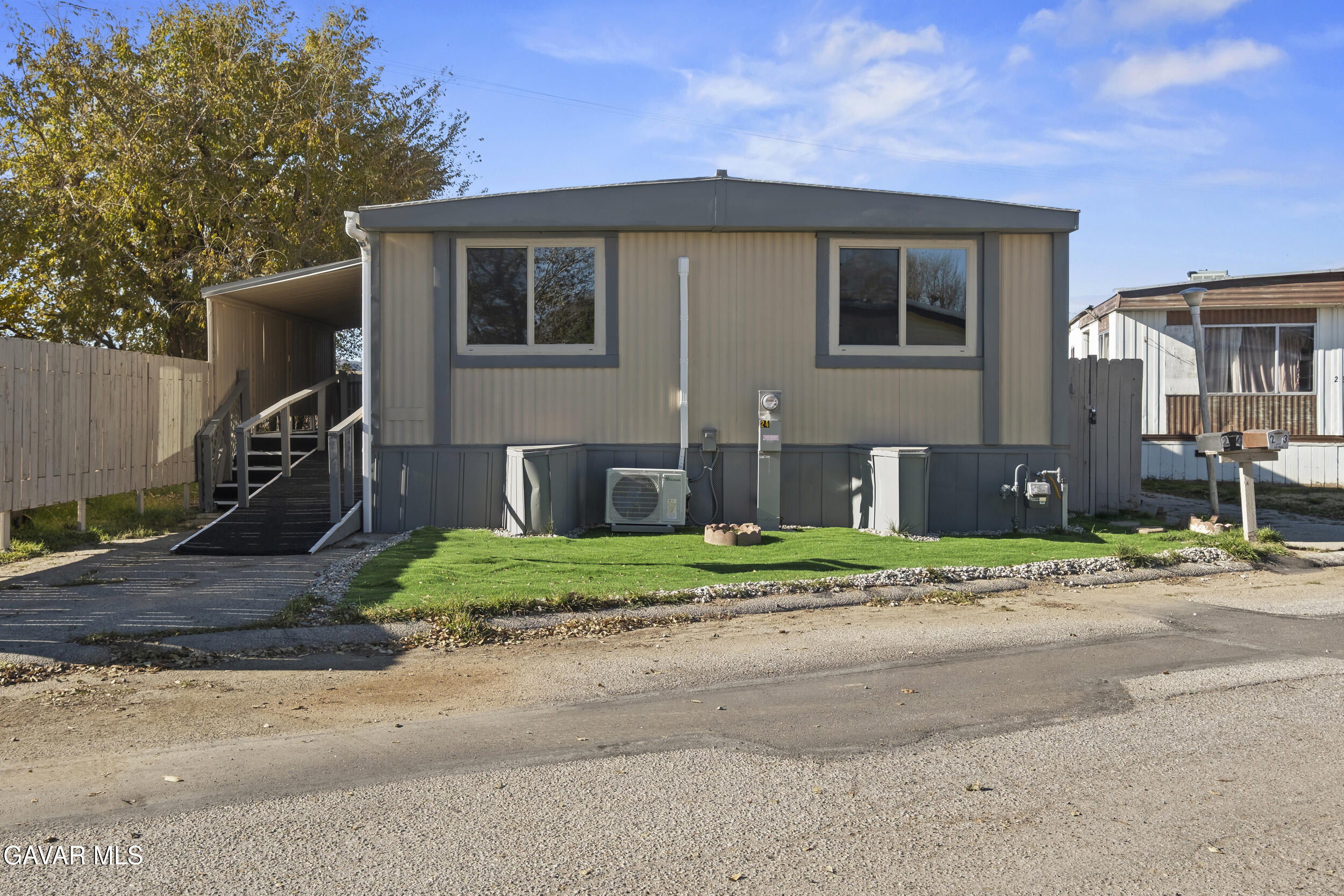 a front view of a house with a yard and outdoor garage