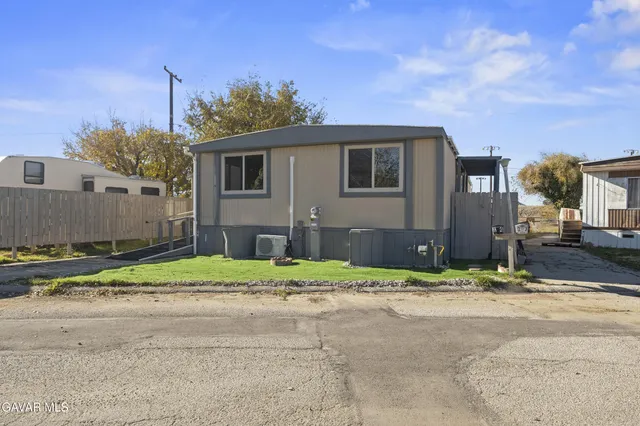 a house that has a tree in front of it