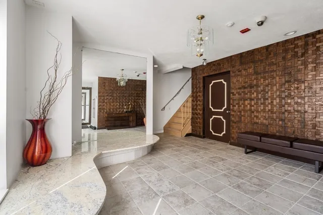 a view of empty room with wooden floor and chair