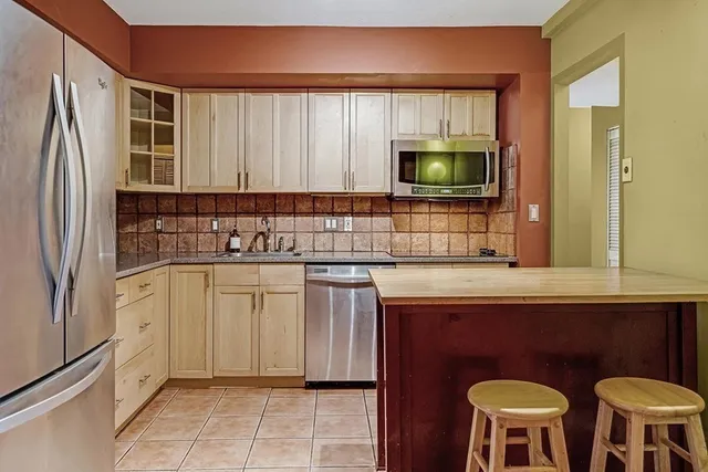 a kitchen with stainless steel appliances a refrigerator and sink