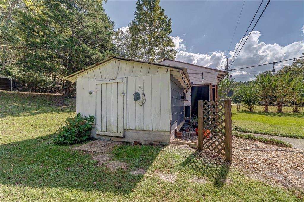 1525 Sloppy Floyd Lake Road Summerville, GA 30747 - Photo 14 of 17 a view of a backyard with a small cabin