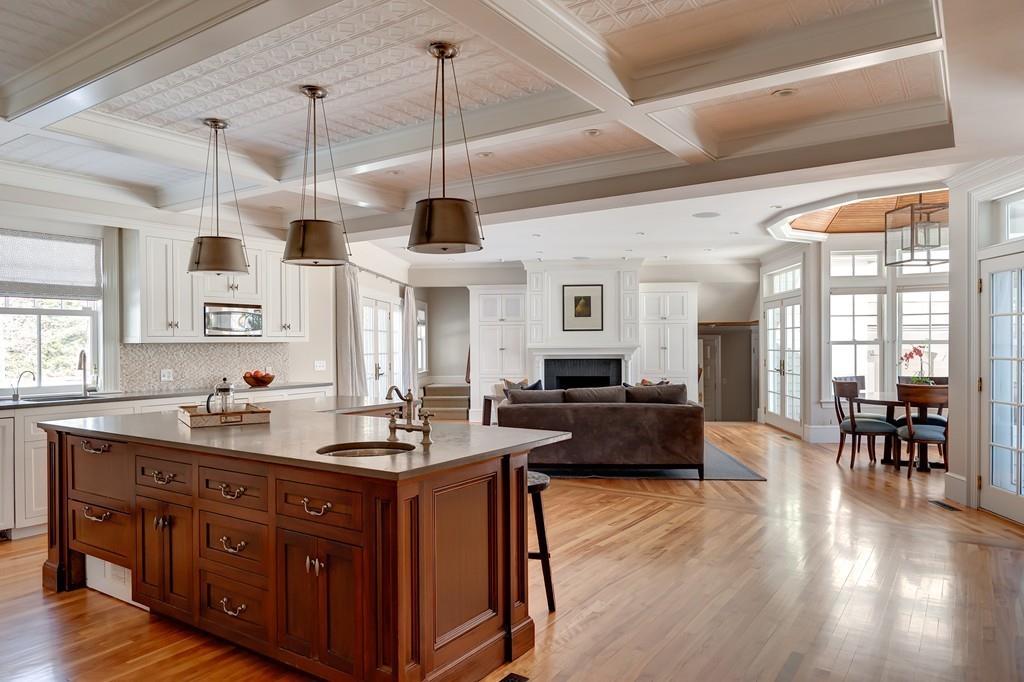 67 Longfellow Road Wellesley, MA 02481 - Photo 5 of 26 a kitchen with stainless steel appliances granite countertop a stove a refrigerator a sink dishwasher a dining table and chairs with wooden floor