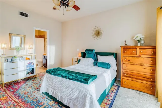 a bedroom with a bed and a dresser in it