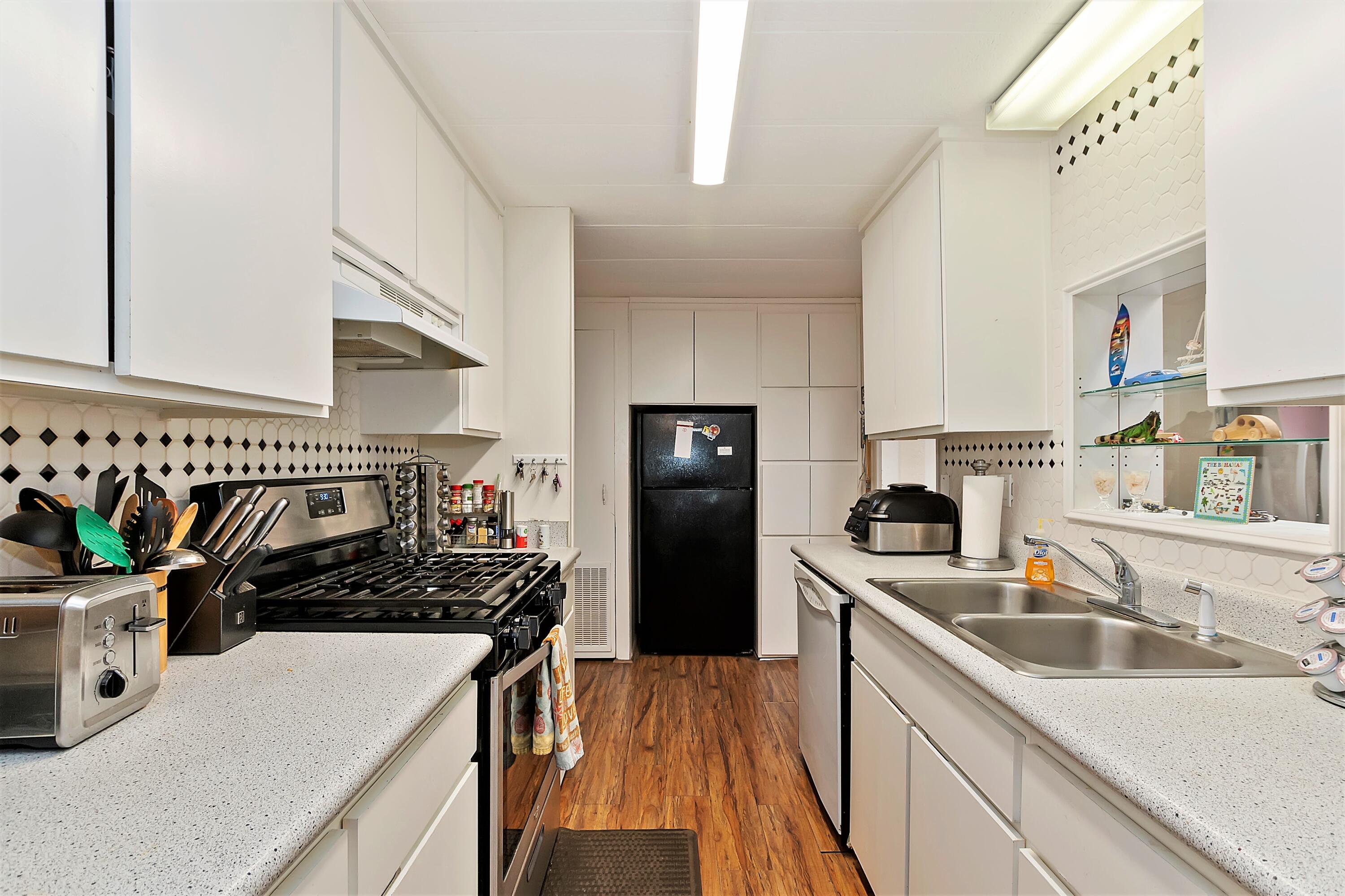 74711 Dillon Road, Unit 331 Desert Hot Springs, CA 92241 - Photo 15 of 53 a kitchen with a sink a stove and refrigerator