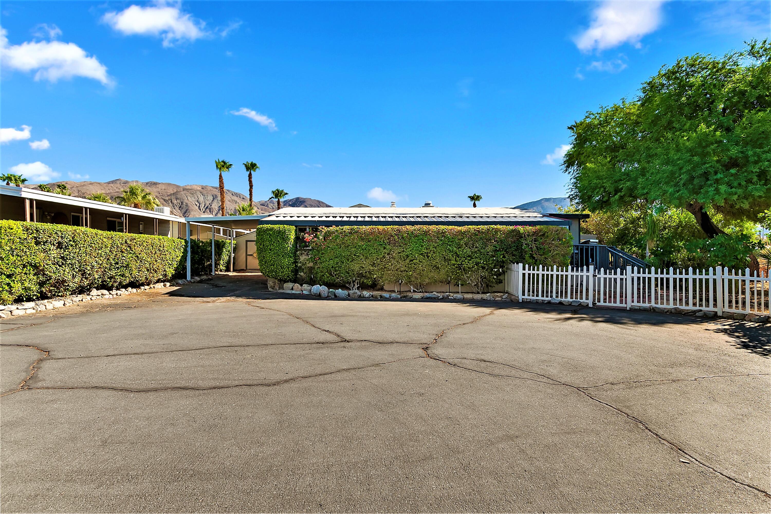 74711 Dillon Road, Unit 331 Desert Hot Springs, CA 92241 - Photo 2 of 53 a view of a back yard of the house and green space