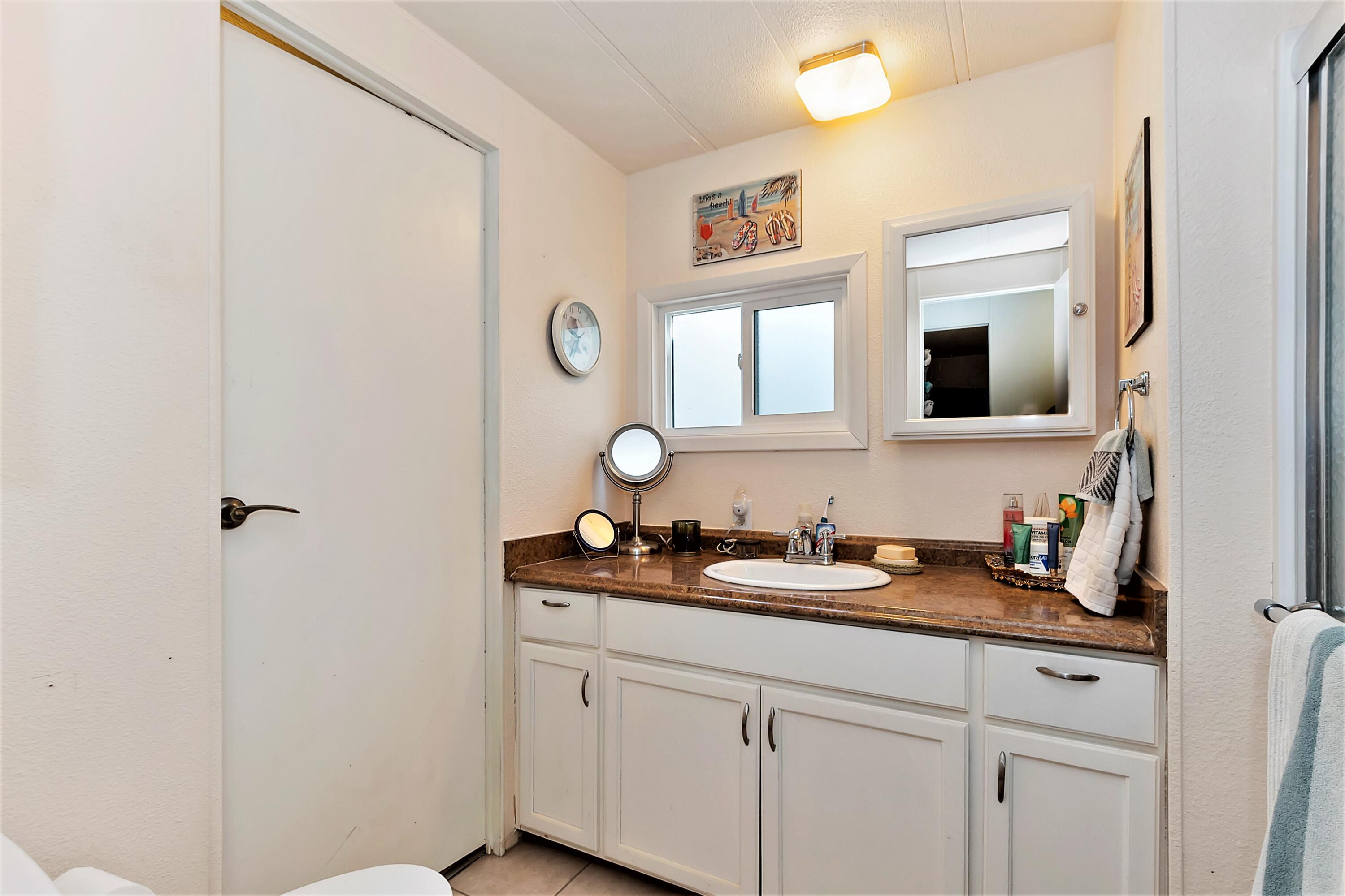 74711 Dillon Road, Unit 331 Desert Hot Springs, CA 92241 - Photo 23 of 53 a bathroom with a double vanity sink and a mirror