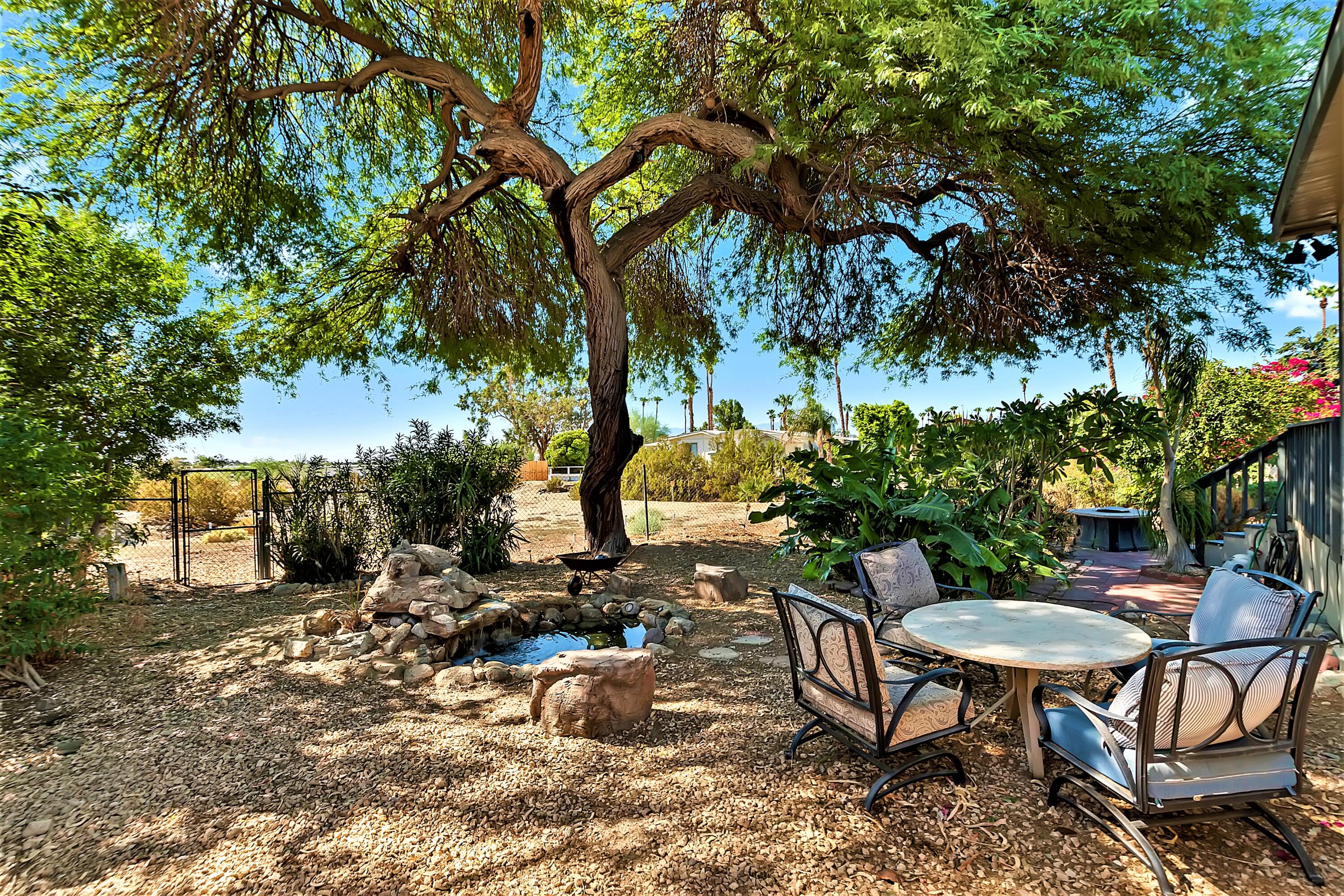 74711 Dillon Road, Unit 331 Desert Hot Springs, CA 92241 - Photo 30 of 53 a view of a chairs and table in the backyard