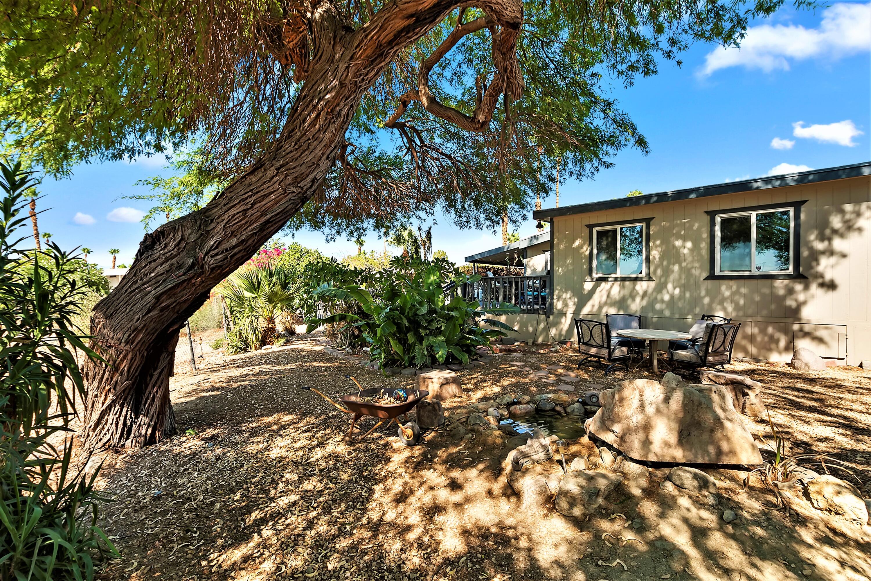 74711 Dillon Road, Unit 331 Desert Hot Springs, CA 92241 - Photo 31 of 53 a view of backyard of the house with outdoor seating