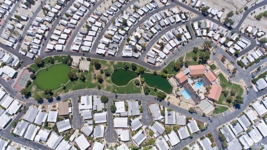 74711 Dillon Road, Unit 331 Desert Hot Springs, CA 92241 - Photo 37 of 53 a green field with lots of white house