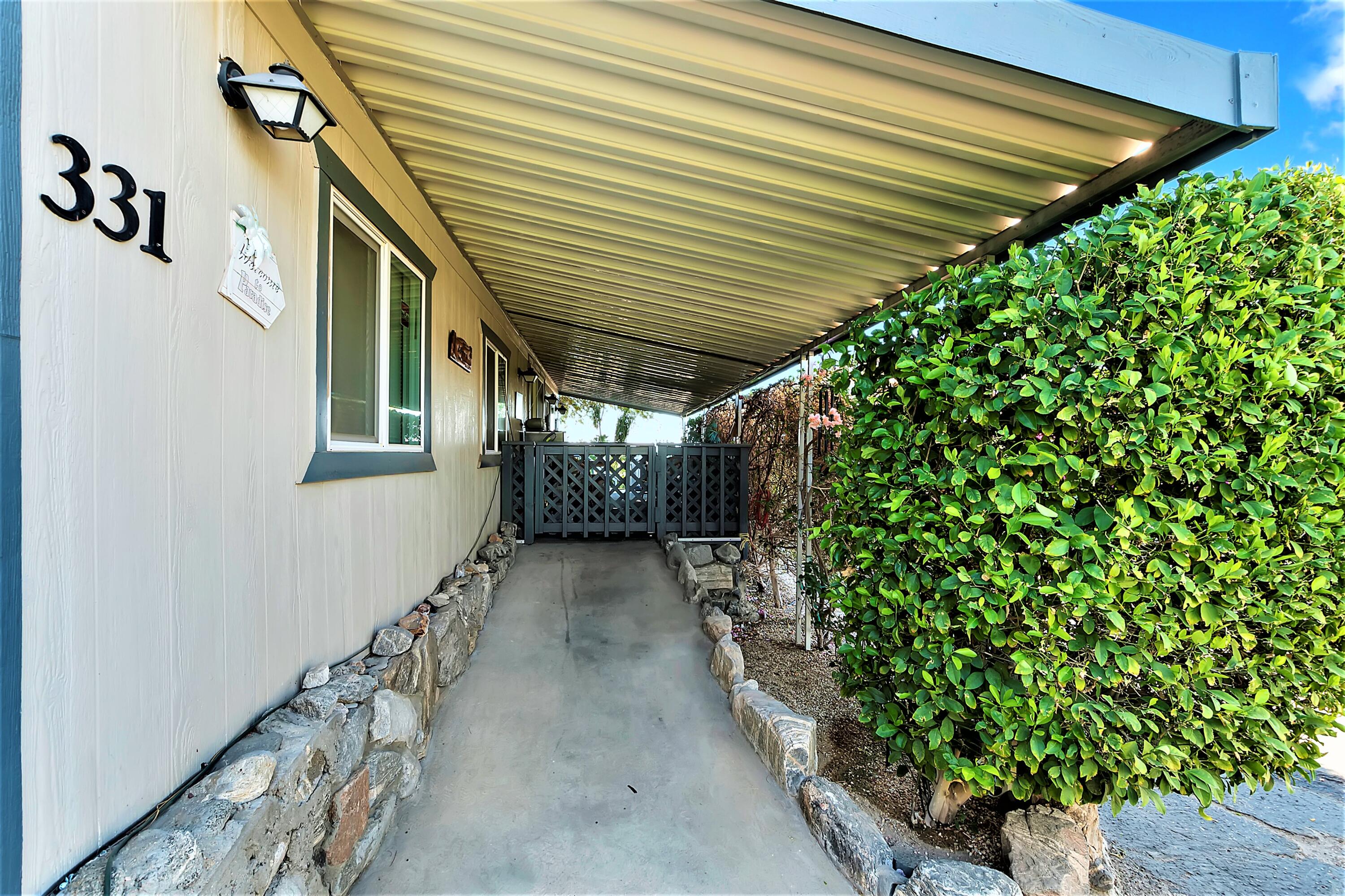 74711 Dillon Road, Unit 331 Desert Hot Springs, CA 92241 - Photo 4 of 53 a view of a pathway with a small yard