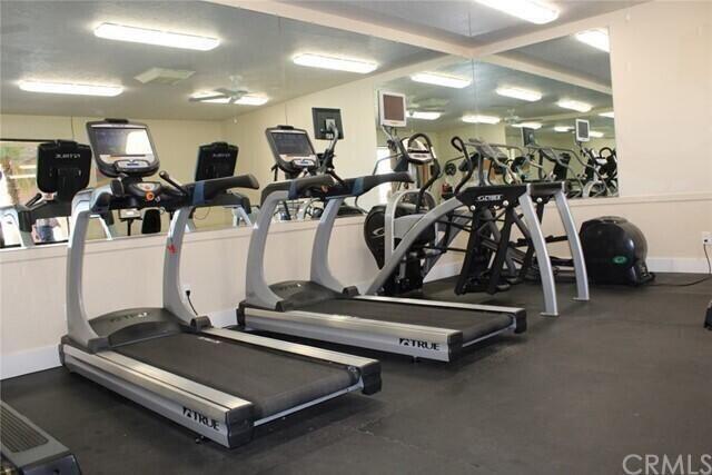 74711 Dillon Road, Unit 331 Desert Hot Springs, CA 92241 - Photo 44 of 53 a room with gym equipment and large mirror