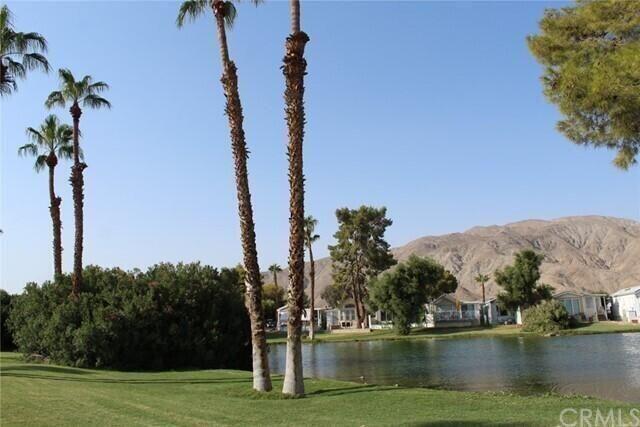 74711 Dillon Road, Unit 331 Desert Hot Springs, CA 92241 - Photo 50 of 53 a view of a lake with a mountain in the background