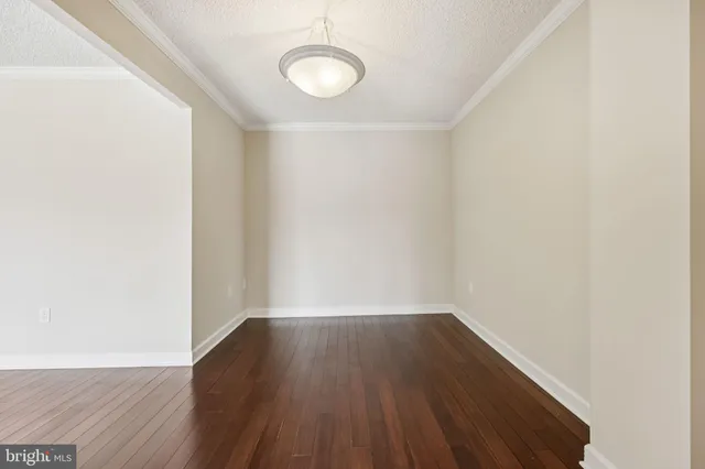 a view of a small space with wooden floor and a window