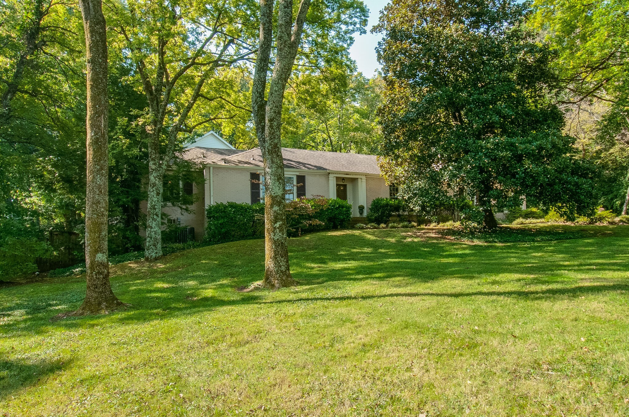 a view of a house with a backyard
