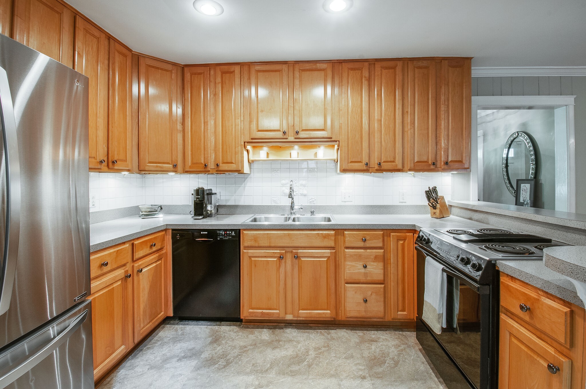 4602 Benton Smith Road Nashville, TN 37215 - Photo 18 of 36 a kitchen with stainless steel appliances granite countertop a stove a sink dishwasher and a refrigerator