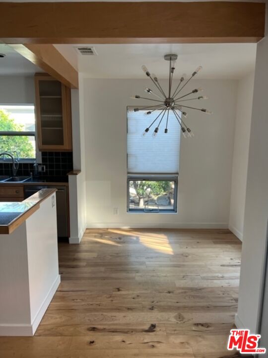 2030 Walnut Avenue Venice, CA 90291 - Photo 5 of 20 a view of an empty room with window and wooden floor