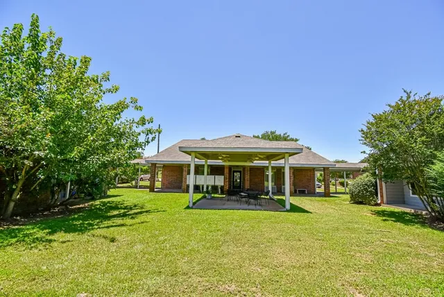 a front view of a house with a yard table and chairs