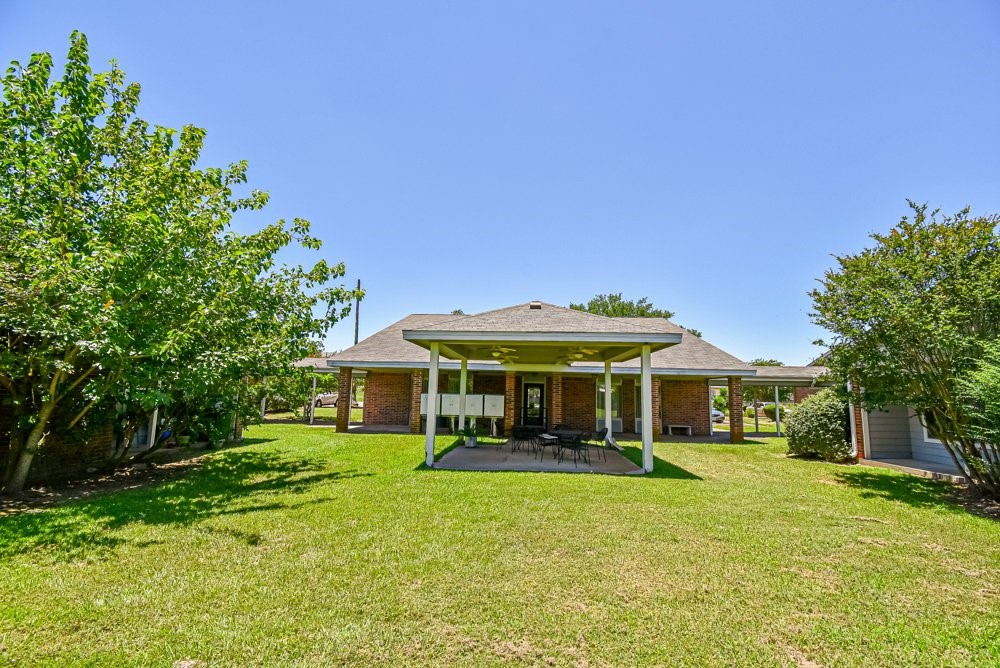 576 Ellen Powell Hempstead, TX 77445 - Photo 3 of 13 a front view of a house with a yard table and chairs