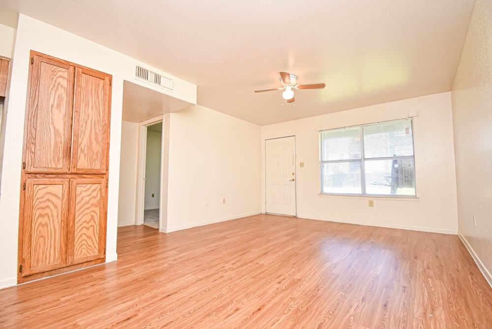 576 Ellen Powell Hempstead, TX 77445 - Photo 8 of 13 an empty room with wooden floor and windows