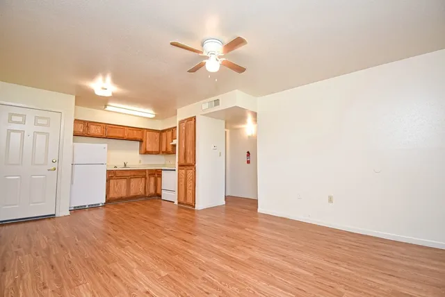 a view of a livingroom with a hardwood floor and a ceiling fan