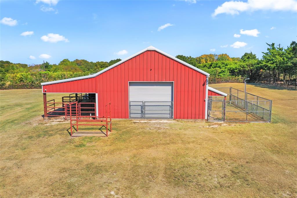 4451 Shiloh Road Midlothian, TX 76065 - Photo 3 of 39 The barn is 30 x 50 with 3 eight foot wide roll down doors. Each roll down door has a cyclone gate in front of it. The gate allows the home owner to open the roll down, let in light and fresh air, while keeping animals in the proper locations. Barn has water, but no septic. Barn has its own electric service with 220 amp plugs. Cement water trough will stay with house. Barn has 8 cameras that will convey. The cameras need Wifi to work. Goat pen on right side of barn. There is a smaller pen inside the goat pen. A pen inside of a pen.