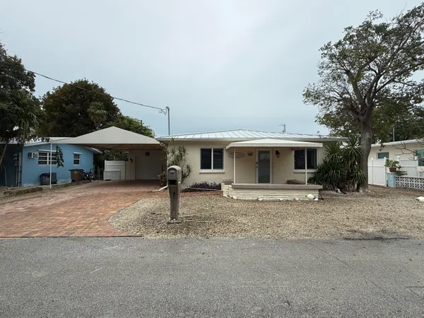 a front view of a house with a yard and a garage