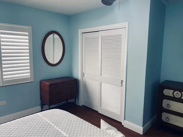 a bedroom with a bed and a chair