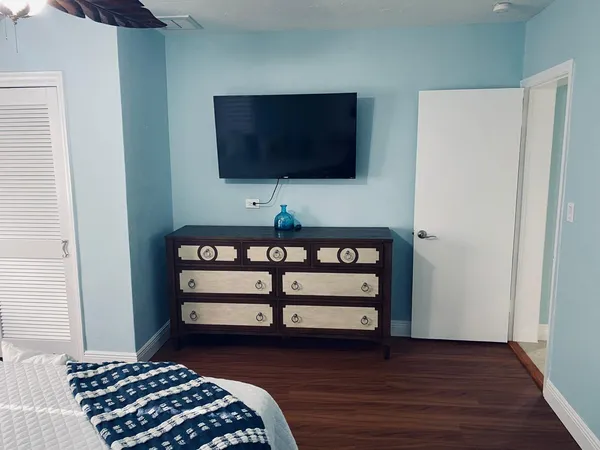a bedroom with a bed and a flat screen tv