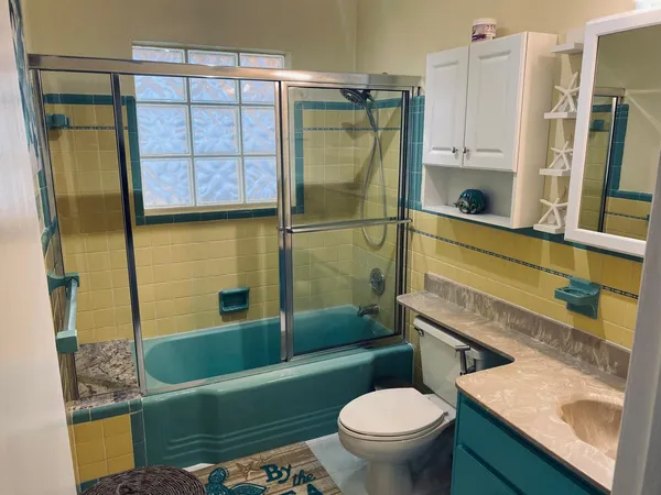 a bathroom with a sink a toilet and bathtub
