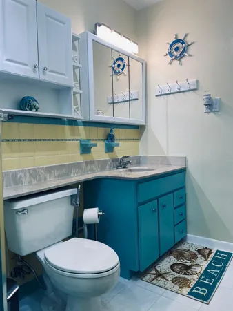 a bathroom with a toilet a sink and mirror