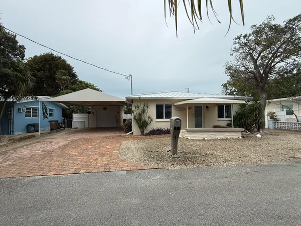 a front view of a house with a yard and a garage