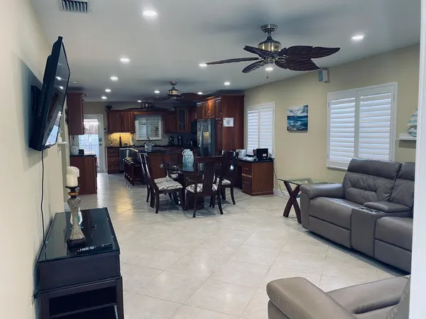 a living room with furniture a clock and a flat screen tv