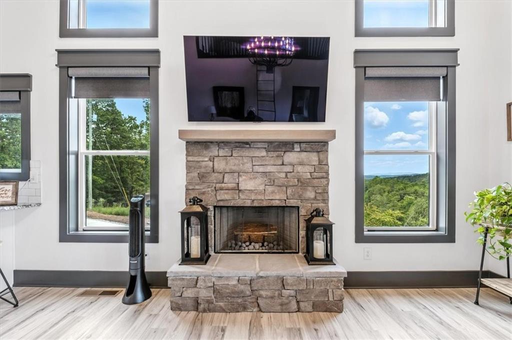 1379 Foxhound Trail Northeast Ranger, GA 30734 - Photo 12 of 42 a living room with a fireplace and a window