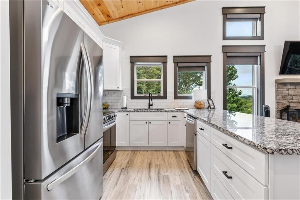 1379 Foxhound Trail Northeast Ranger, GA 30734 - Photo 17 of 42 a large white kitchen with sink and window