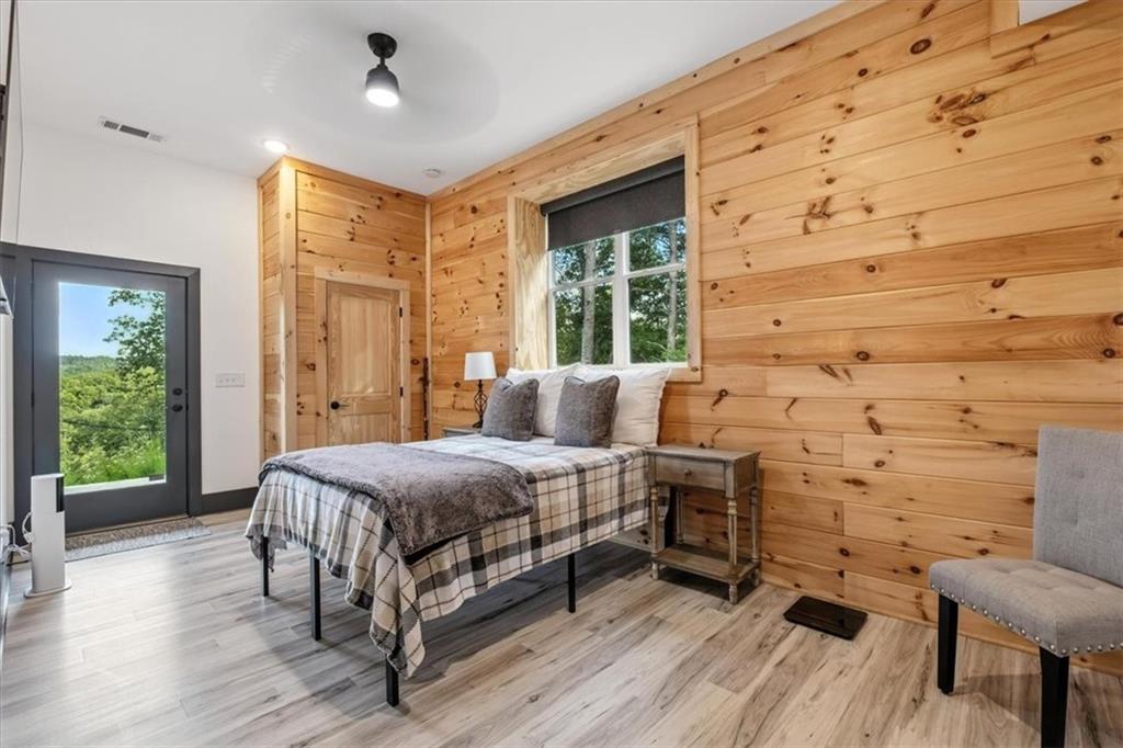 1379 Foxhound Trail Northeast Ranger, GA 30734 - Photo 30 of 42 a bedroom with a bed wooden floor and window