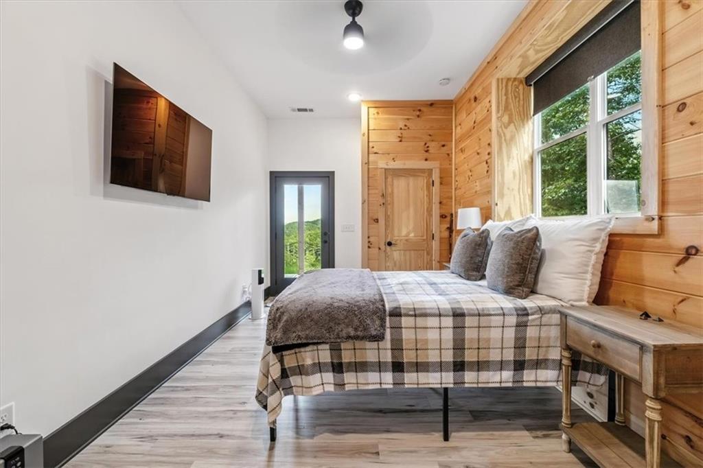 1379 Foxhound Trail Northeast Ranger, GA 30734 - Photo 31 of 42 a bedroom with a bed and wooden floor