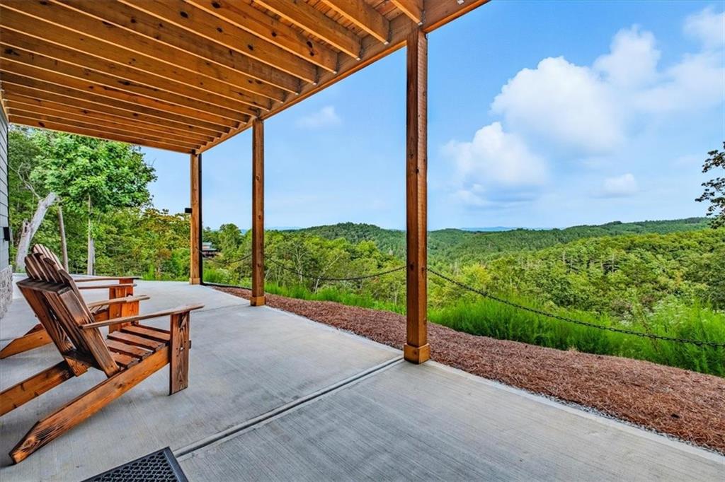 1379 Foxhound Trail Northeast Ranger, GA 30734 - Photo 4 of 42 a backyard of a house with a swing table and chairs