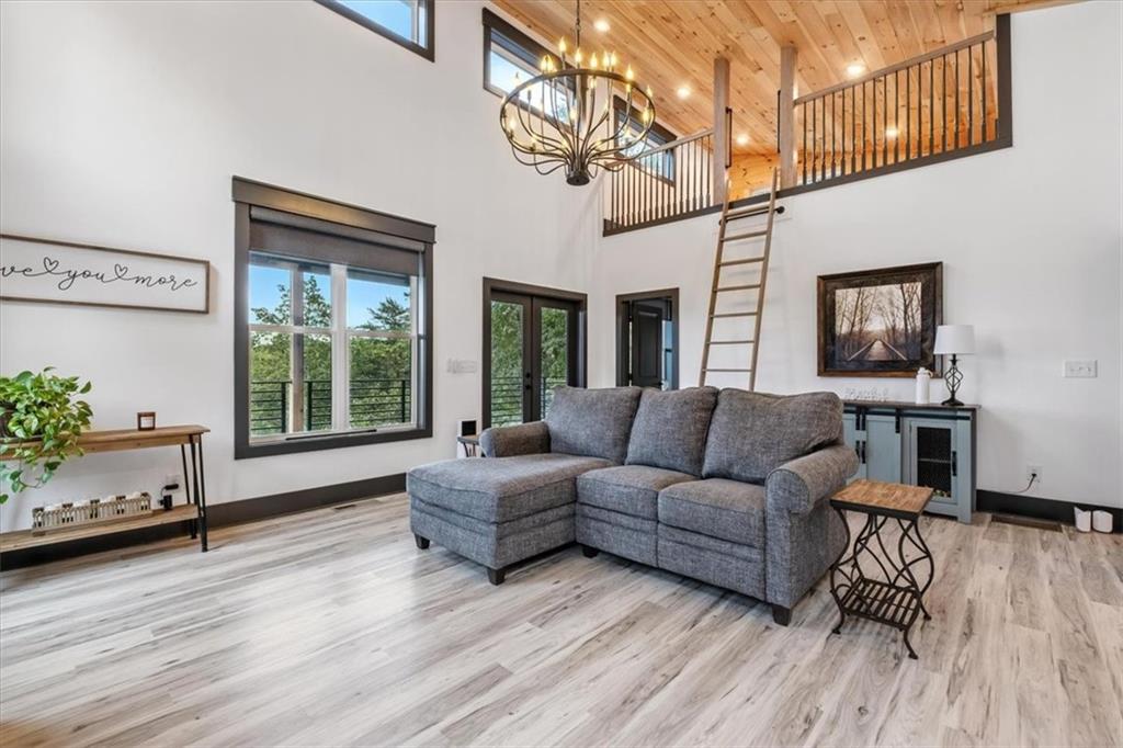 1379 Foxhound Trail Northeast Ranger, GA 30734 - Photo 7 of 42 a living room with furniture and a wooden floor