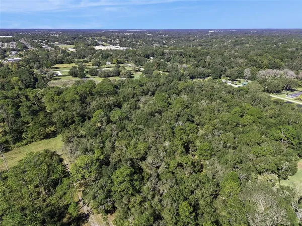 an aerial view of a houses with a yard