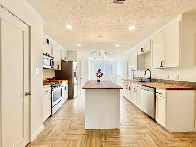 a spacious bathroom with a double vanity sink and a mirror